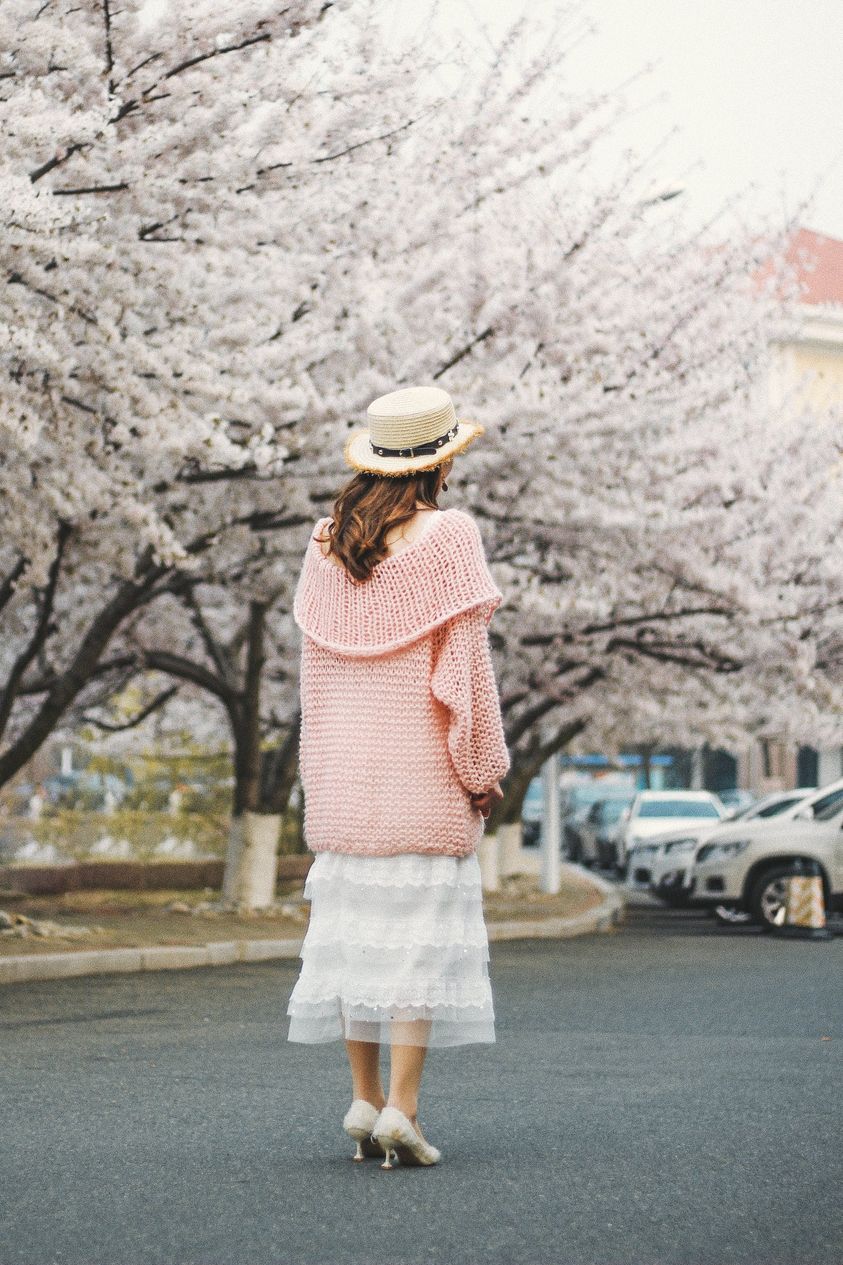 May be an image of 1 person, beret, stone-fruit tree and outdoors