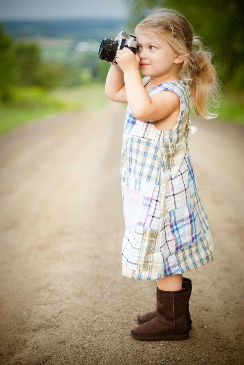 May be an image of 1 person, baby, sundress and boots