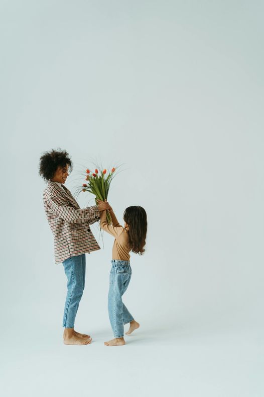 May be an image of 2 people, child and flower